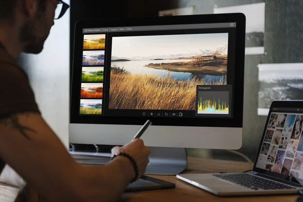 Man editing photos on a computer designing services